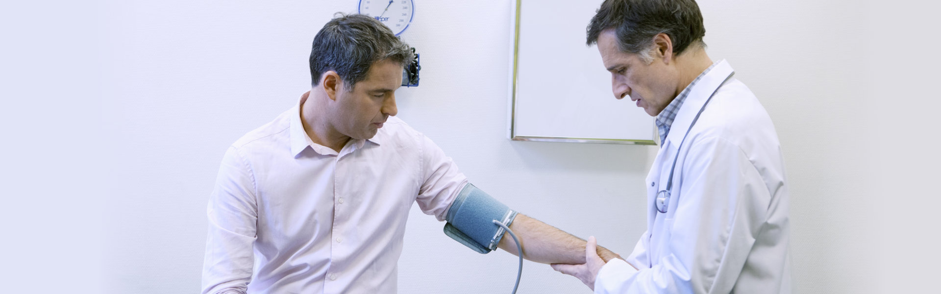 doctor checks blood pressure of the patient